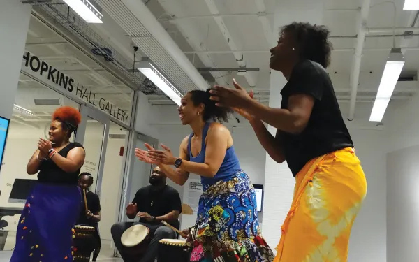 Dancers with bongo player in background