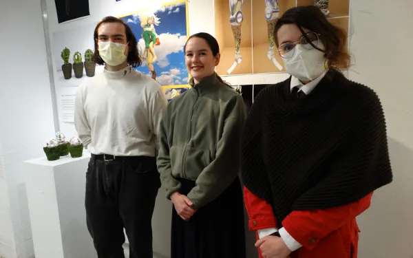 Three people wearing face masks 