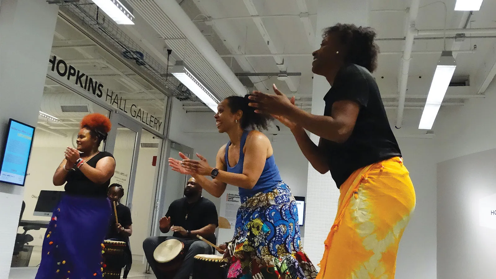 Dancers with bongo player in background