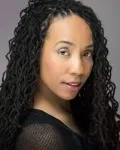 Woman with long black hair and a black shirt